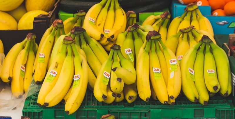 Ripe bananas on sale at a fresh produce market.