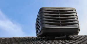 Outdoor unit of an evaporative air conditioning system installed on the roof of a house.