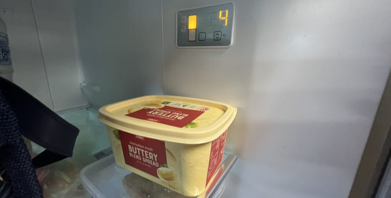 inside of refrigerator showing the temperature is 4 degrees celsius